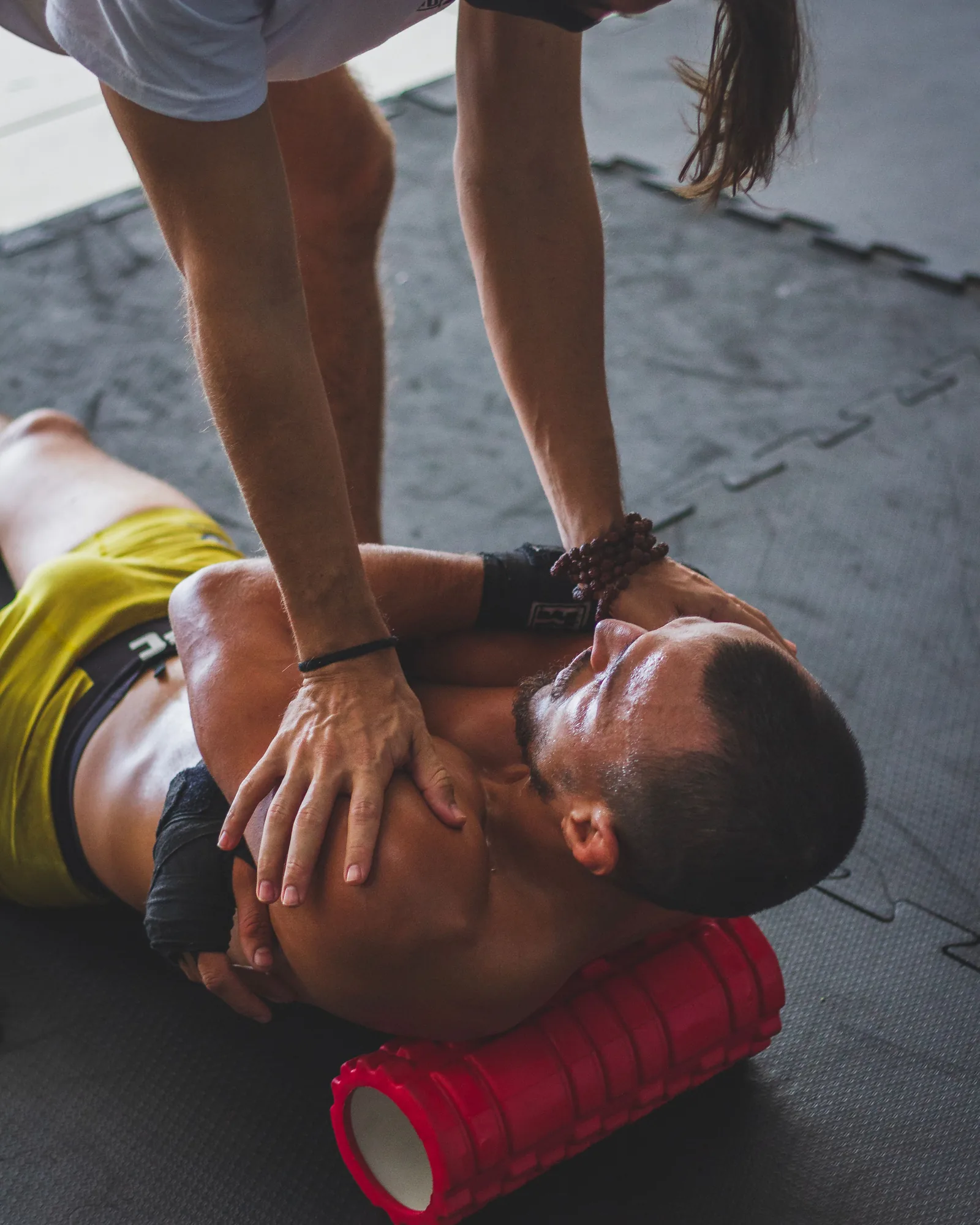 Athlete completing mobility and recovery work with coach