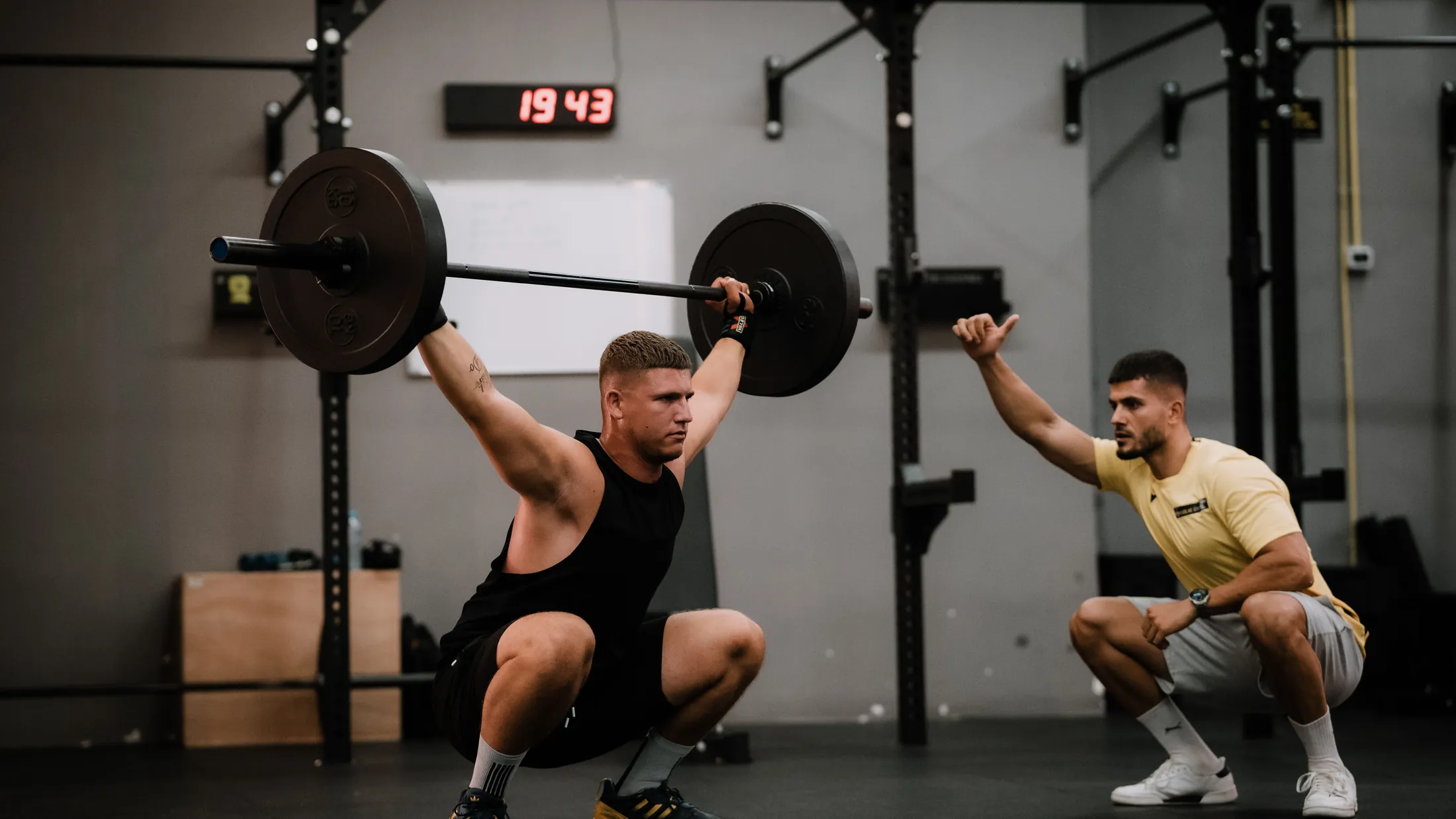 Athlete completing strength training with professional coaching